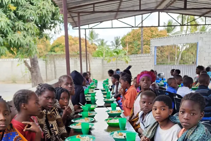 Long table set for children at the community lunch